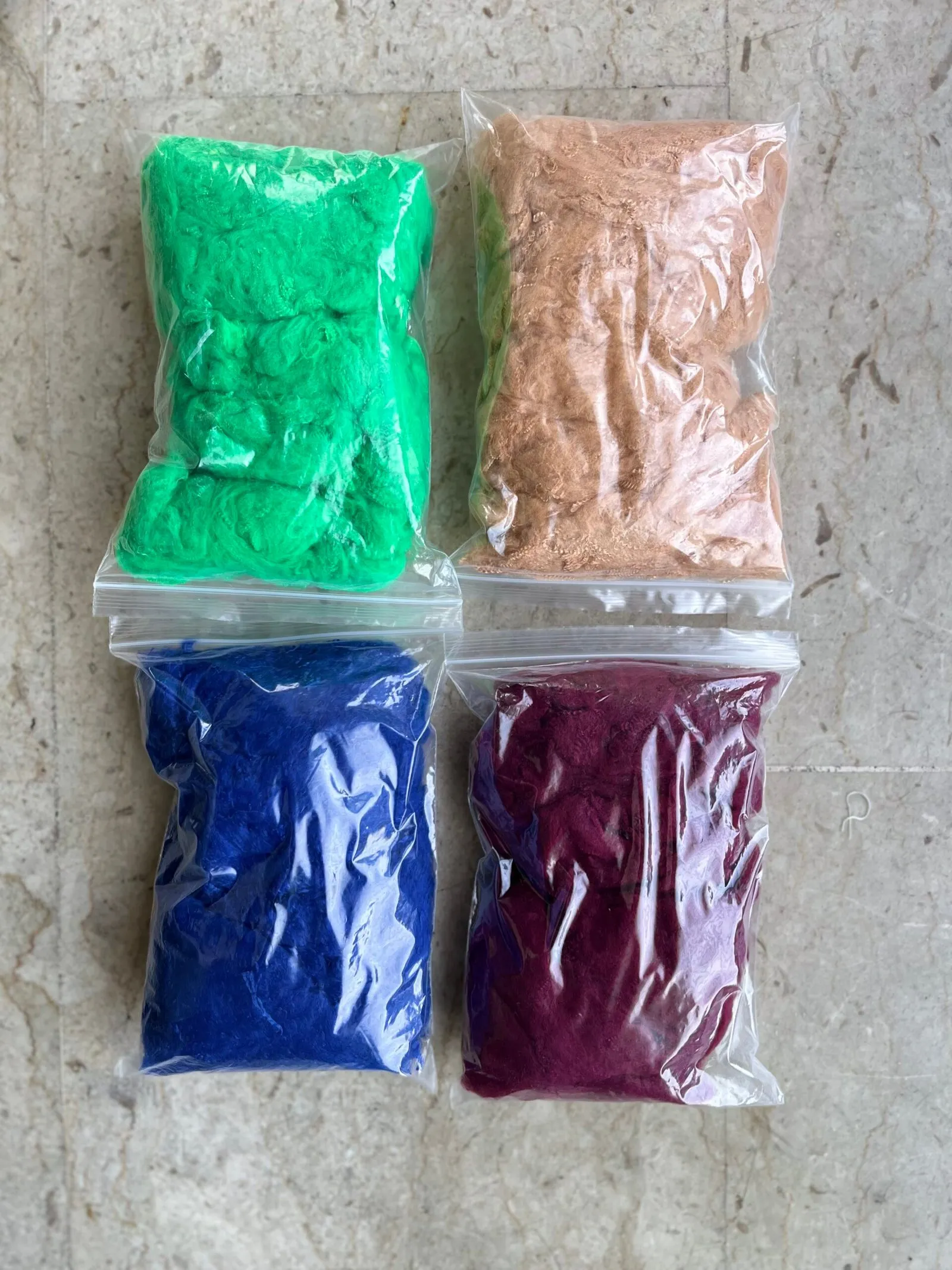 Recycled polyester fibre samples in four colours