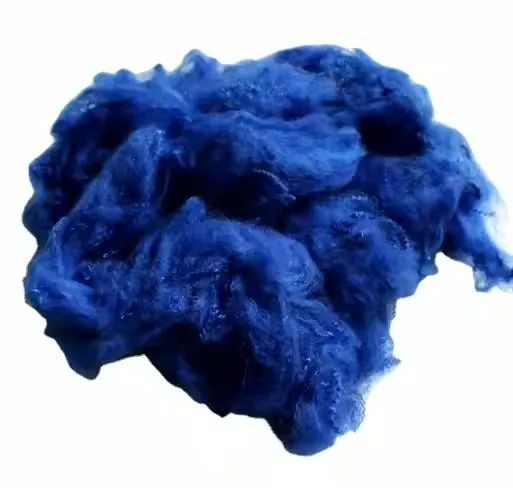 A tuft of blue dyed fibre on a white background